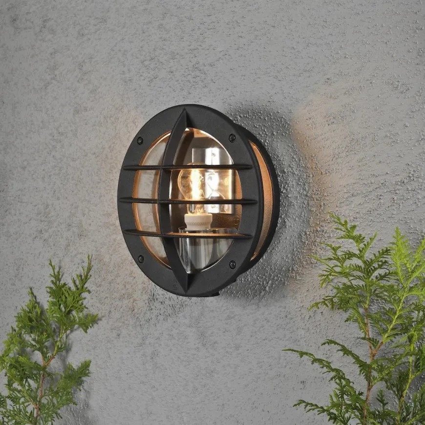 Oden vegglampe utendørs IP23 m/stikkontakt - Svart/klart glass